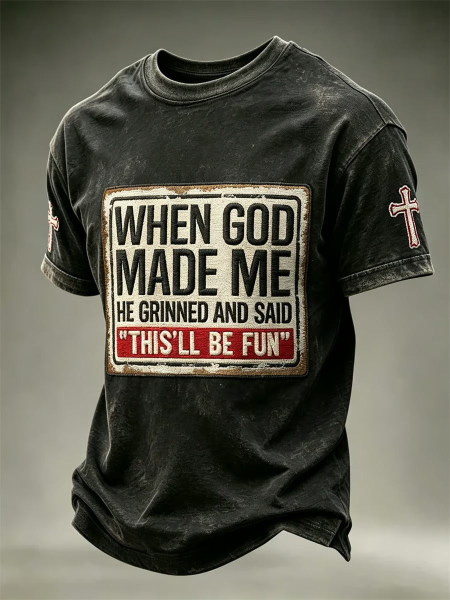 Distressed charcoal men's faith t-shirt with When God Made Me He Grinned vintage patch print and cross sleeve