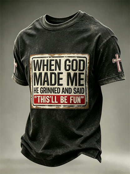 Distressed charcoal men's faith t-shirt with When God Made Me He Grinned vintage patch print and cross sleeve