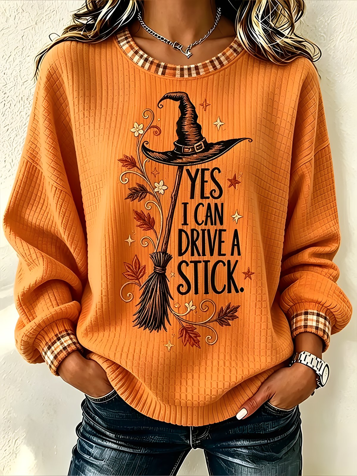 Women's orange witch graphic Halloween sweatshirt with plaid trim