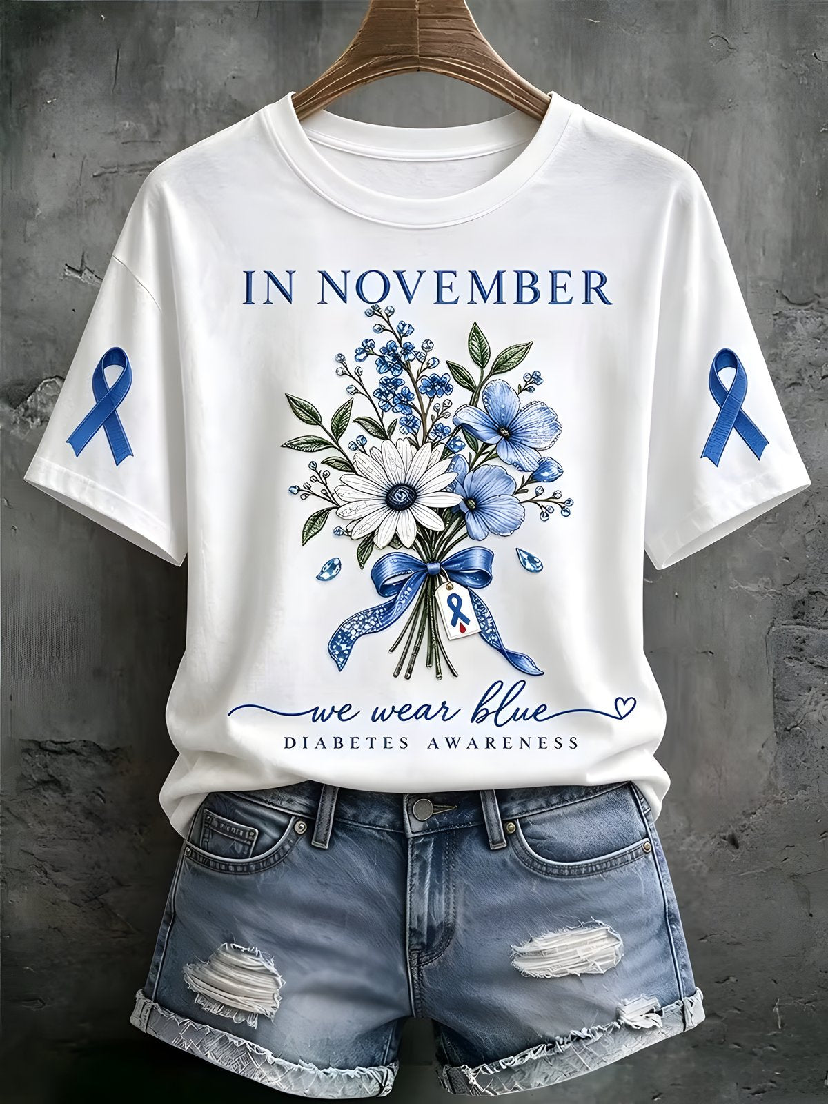 White women's diabetes awareness T-shirt with a blue floral bouquet and blue ribbon sleeve graphics