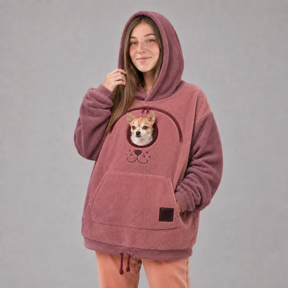 Pink pet carrier hoodie with a small dog in the built-in pouch