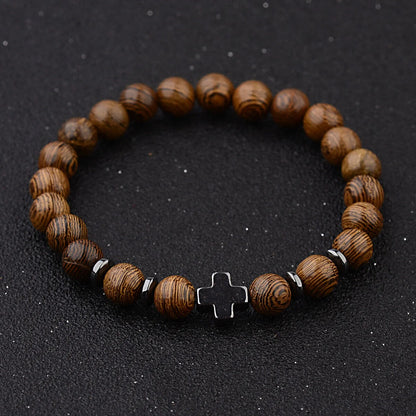 Cross wooden bead bracelet close up on dark background