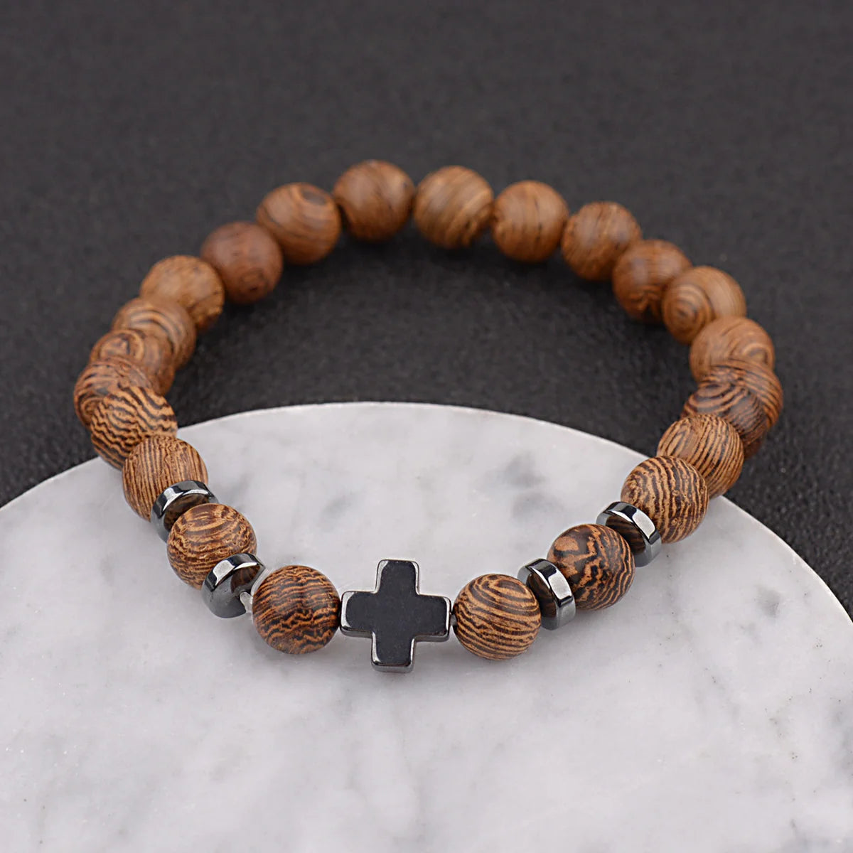 Christian cross wooden bead bracelet on white marble