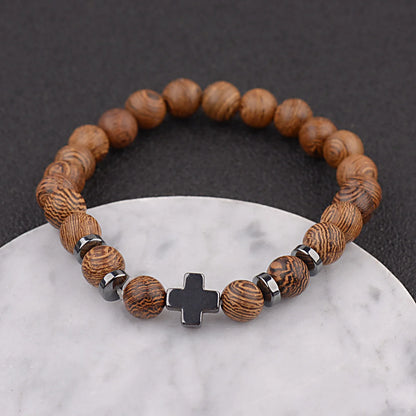 Christian cross wooden bead bracelet on white marble