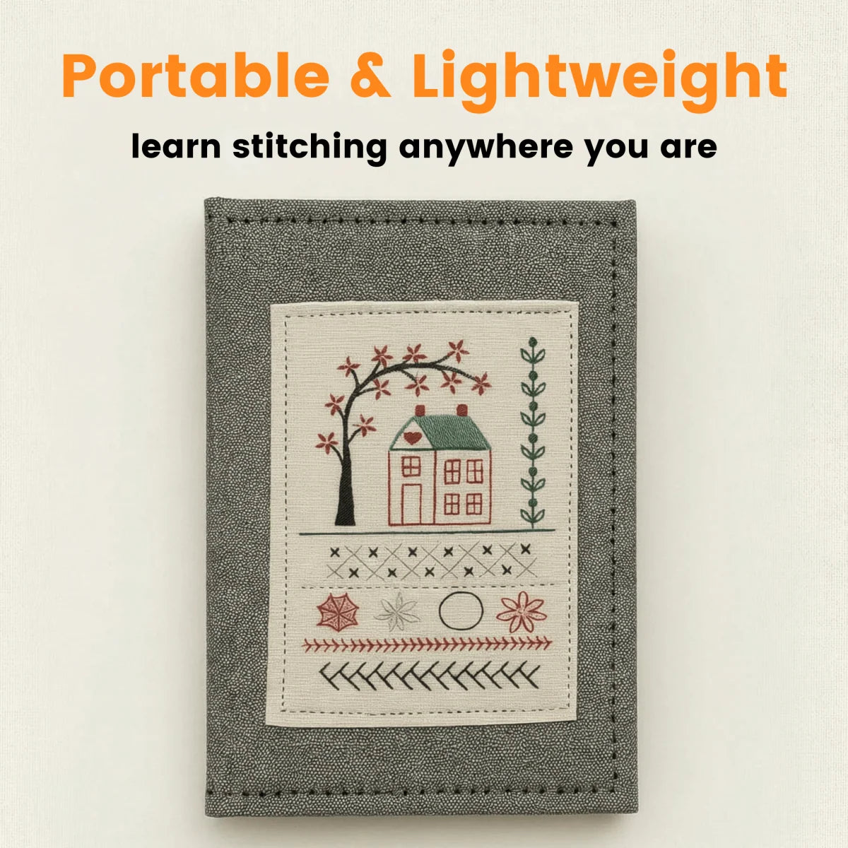 Portable embroidery stitch book with a gray cover and stitched house design