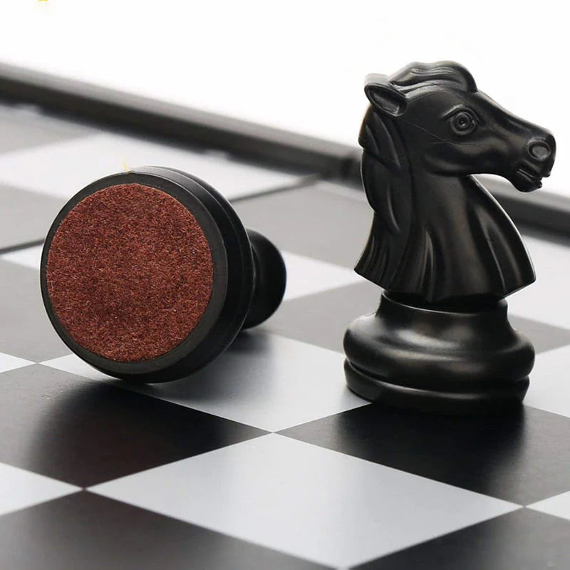 Detailed view of black weighted chess pieces on magnetic board