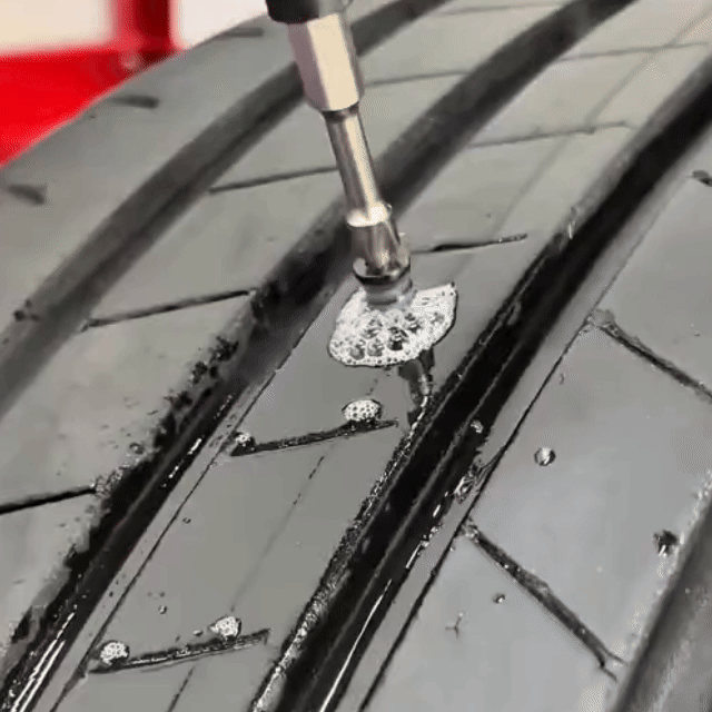 Electric driver installing rubber nail into tire