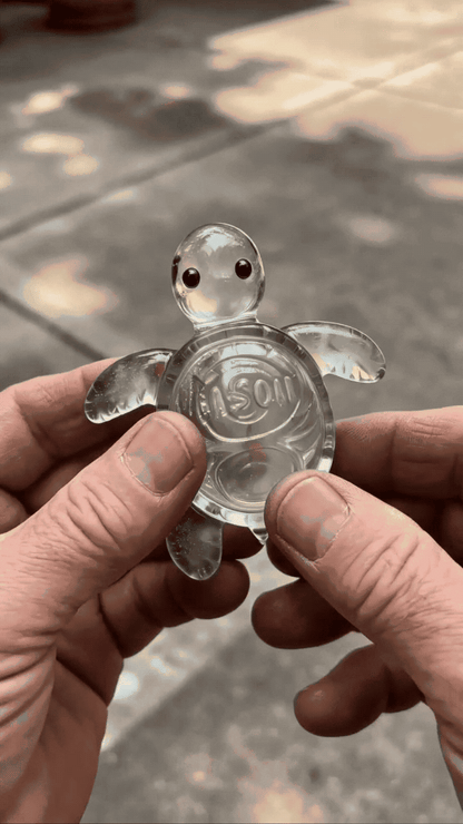 Palm-sized translucent glass turtle held in hand as an emotional support keepsake