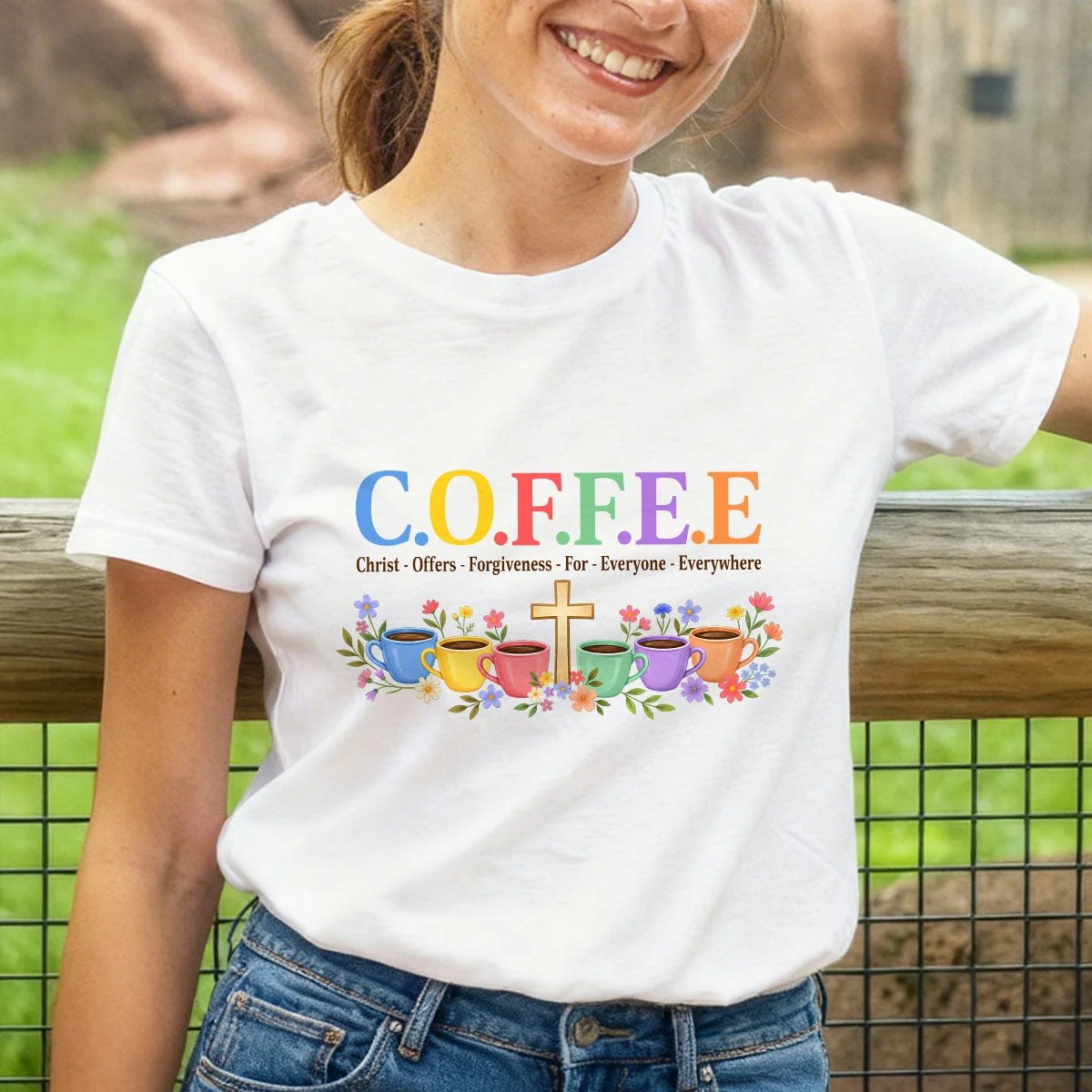 White Christian coffee graphic unisex T-shirt worn outdoors with denim