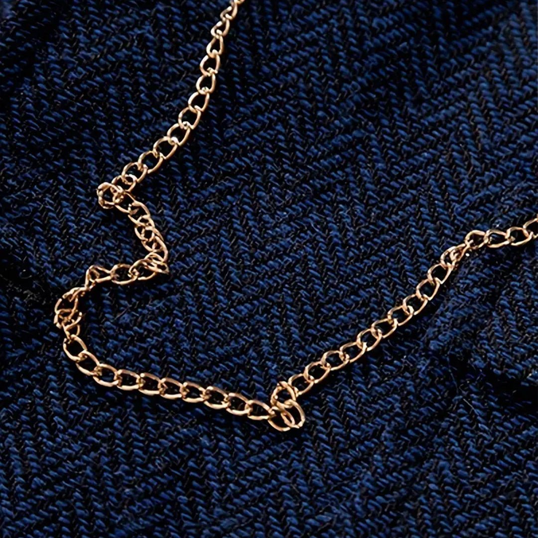 Removable signature gold chain detail on men's tweed waistcoat