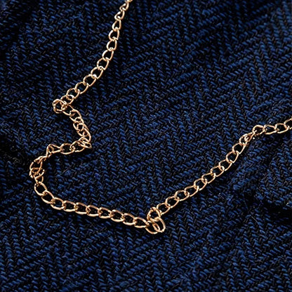 Removable signature gold chain detail on men's tweed waistcoat