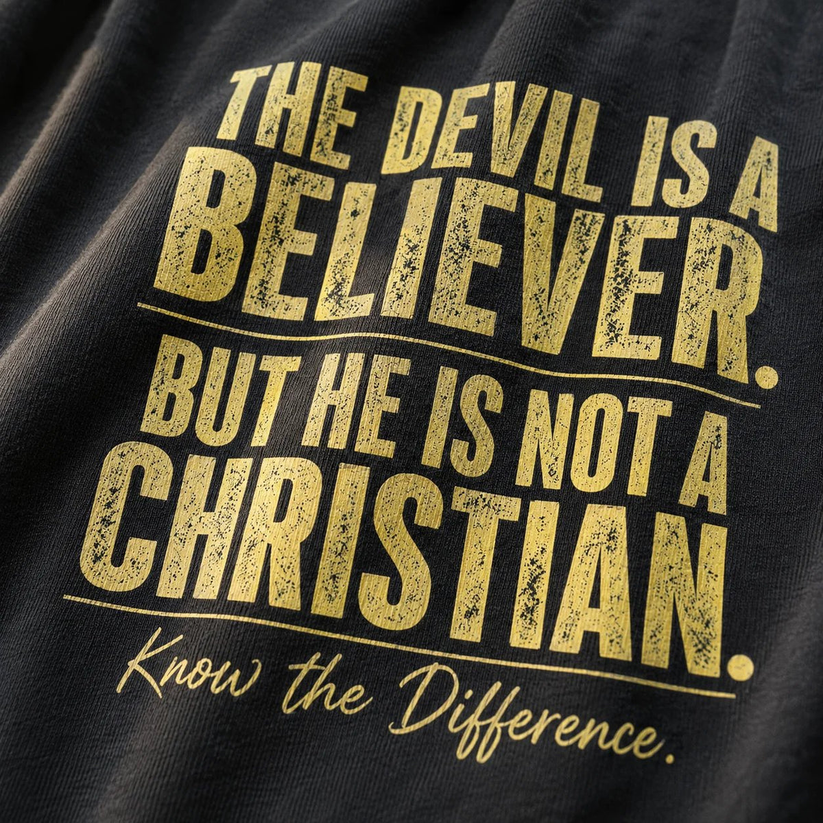 Close-up of distressed lettering on the Devil Believer Christian T-shirt