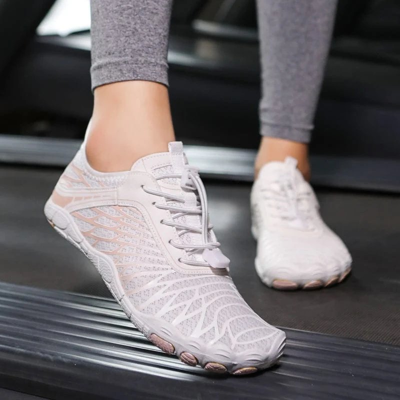 Woman walking outdoors wearing white LORO PRO barefoot shoes