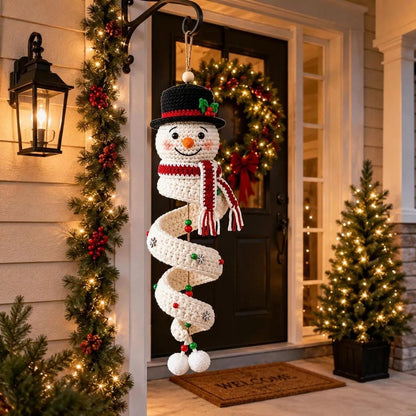 Crochet snowman ornament hanging beside a festive front door