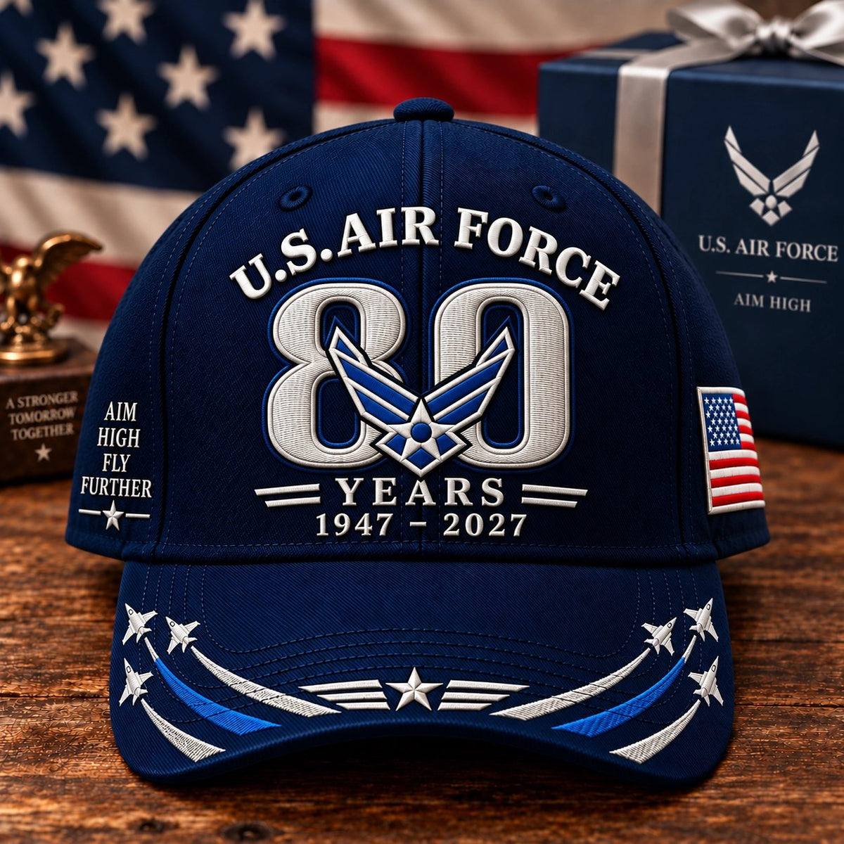 Air Force 80th Anniversary cap on wooden table with American flag and gift box