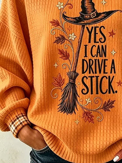 Orange Halloween sweatshirt with plaid cuff and ribbed hem detail