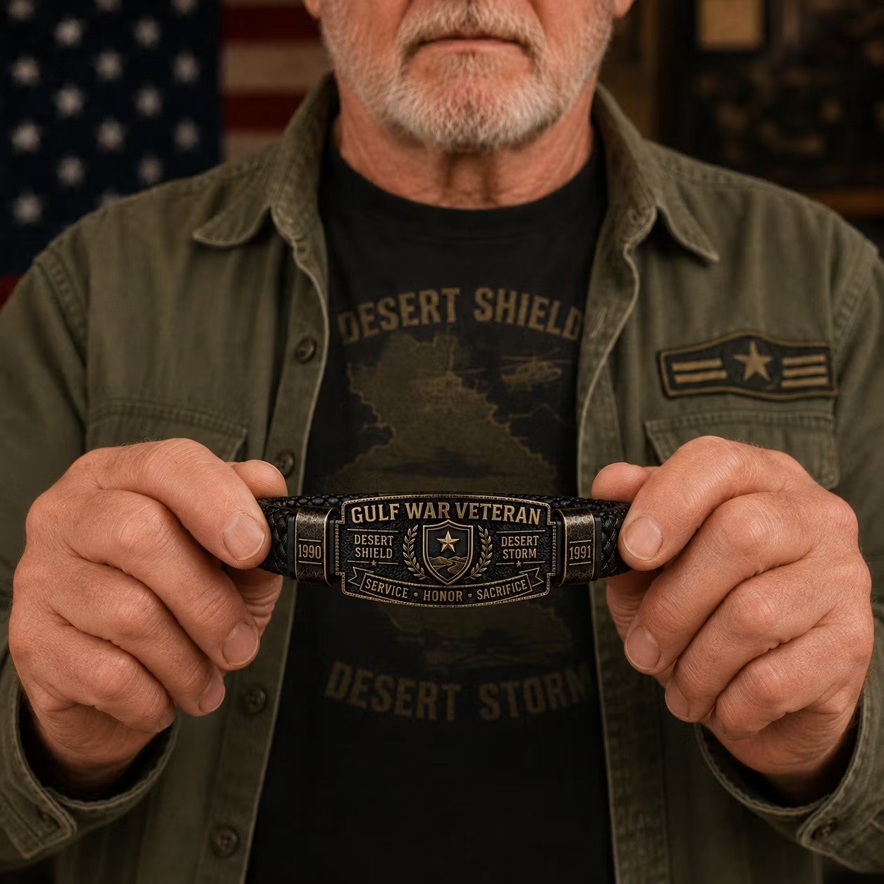 Veteran in Desert Shield shirt holding Gulf War Honor Bracelet in both hands