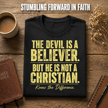 Devil Believer Christian T-shirt folded beside a Bible