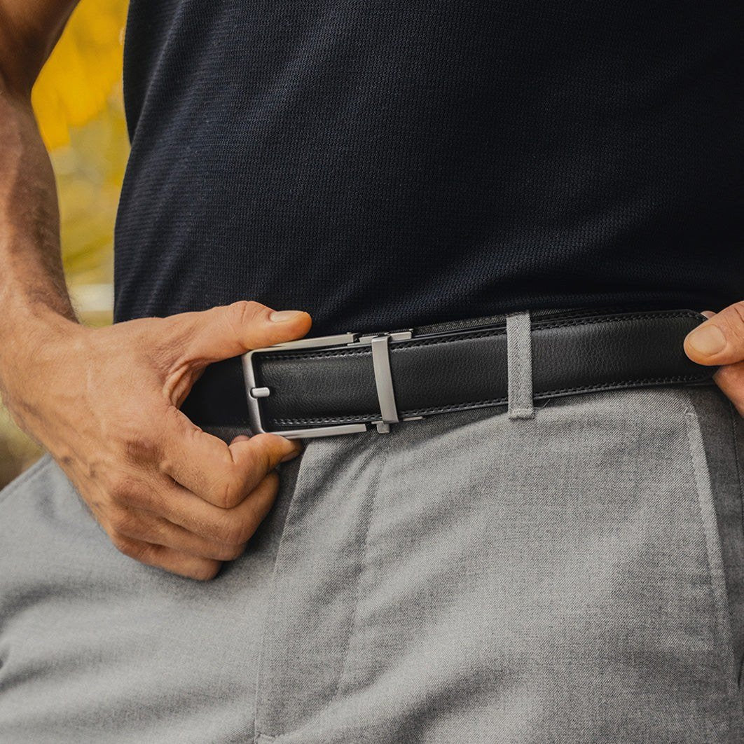 Black no-hole leather belt worn with gray trousers