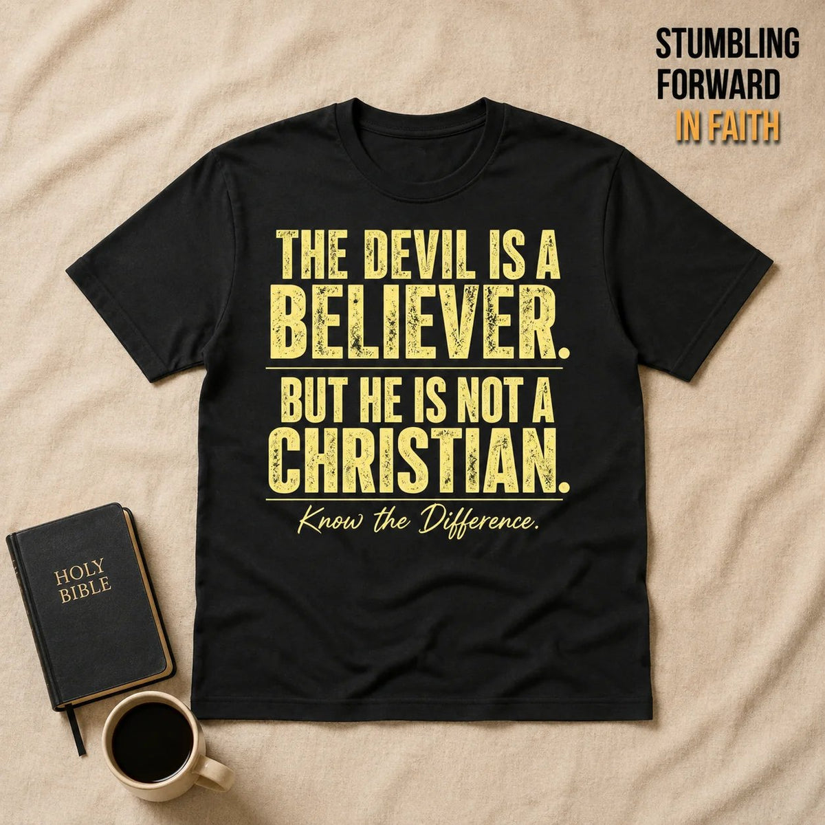 Devil Believer Christian T-shirt laid flat beside a Bible
