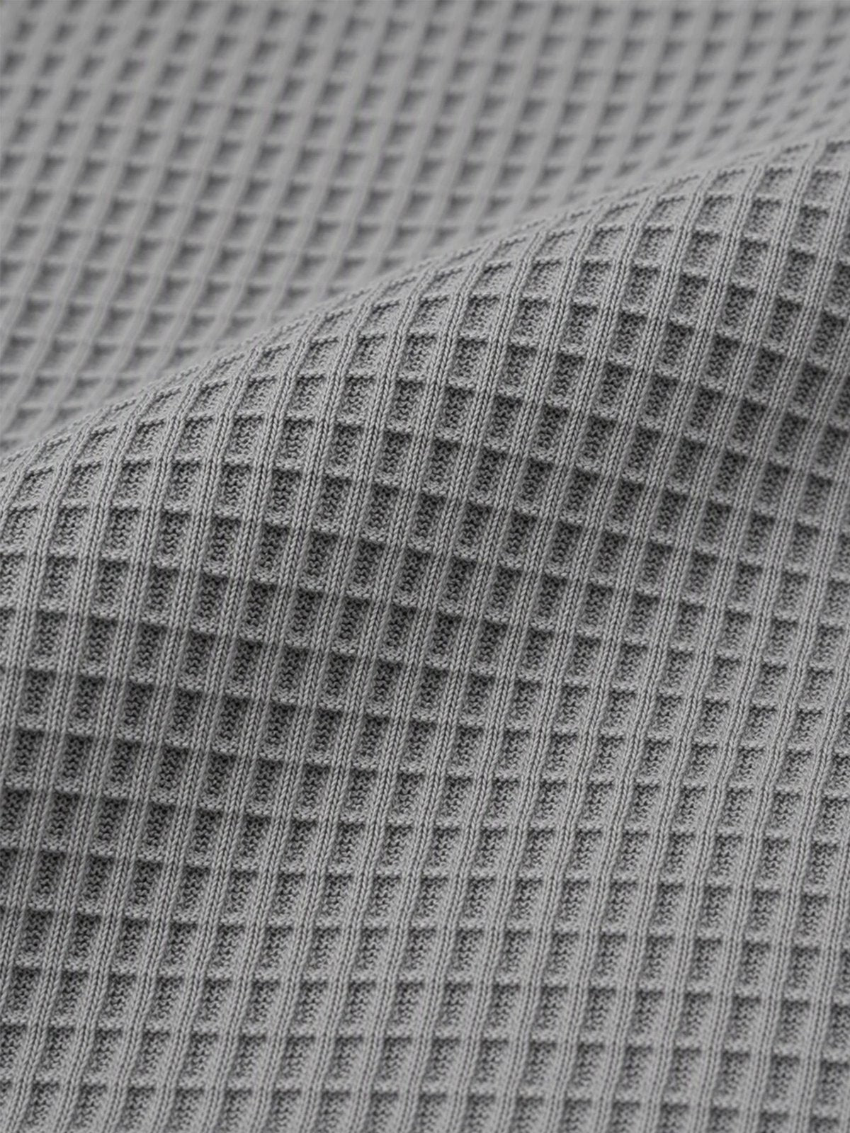 Grey waffle knit fabric close-up