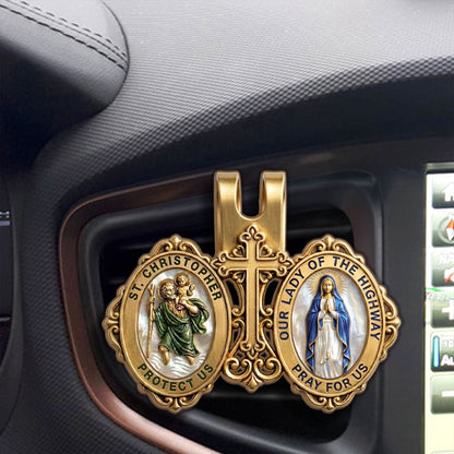 St. Christopher and Mary visor clip displayed inside car interior