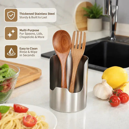 Stainless steel utensil organizer holding spoons beside a kitchen sink