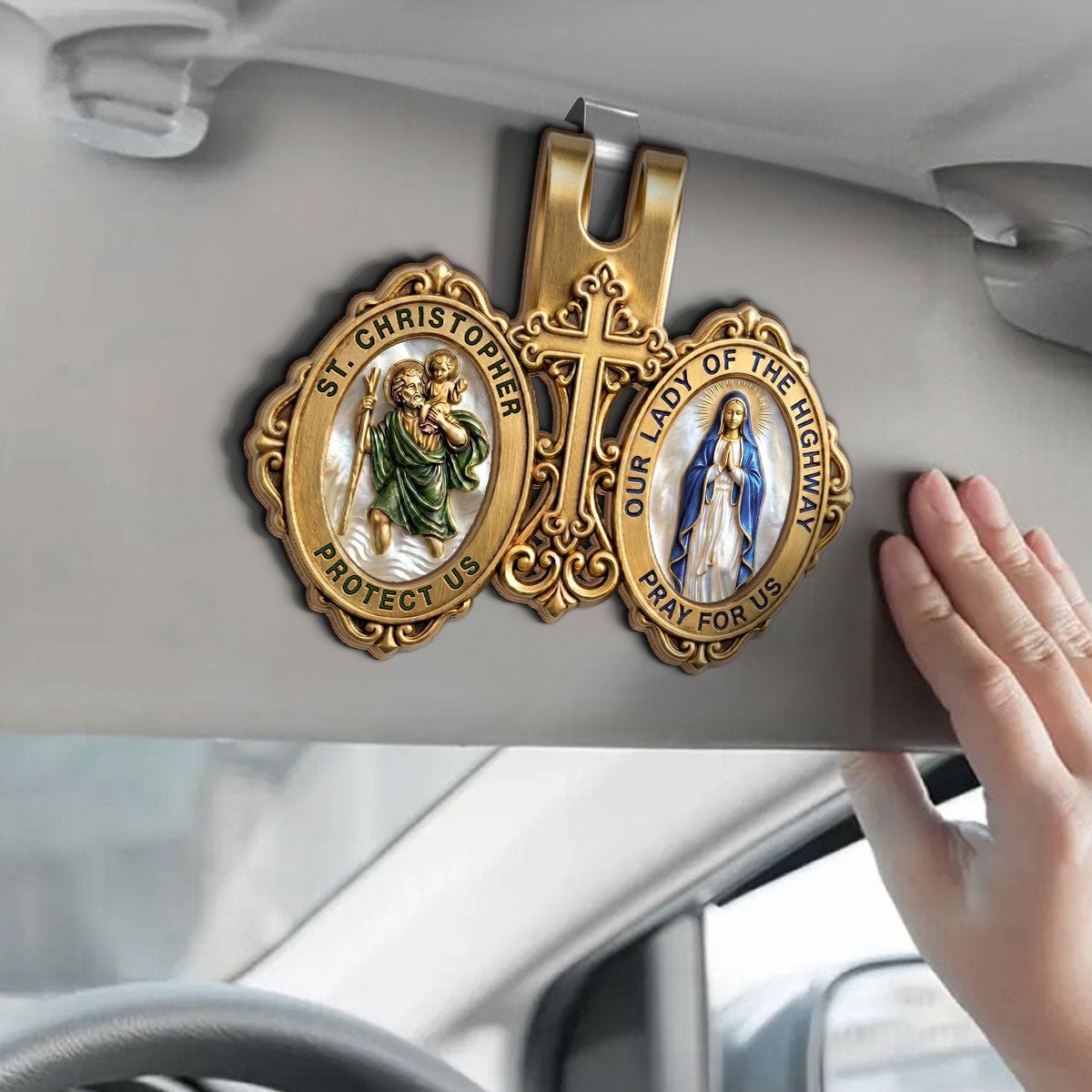Hand clipping Catholic St. Christopher visor clip onto car sun visor