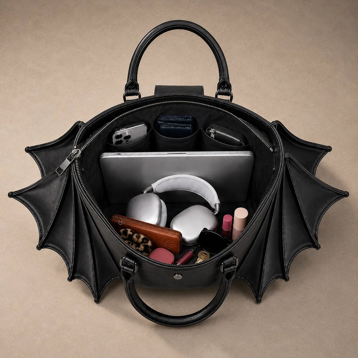 Black gothic batwing tote open main compartment with example daily essentials