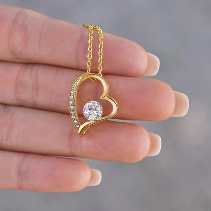 Yellow gold finish daughter heart necklace held in a hand to show pendant detail